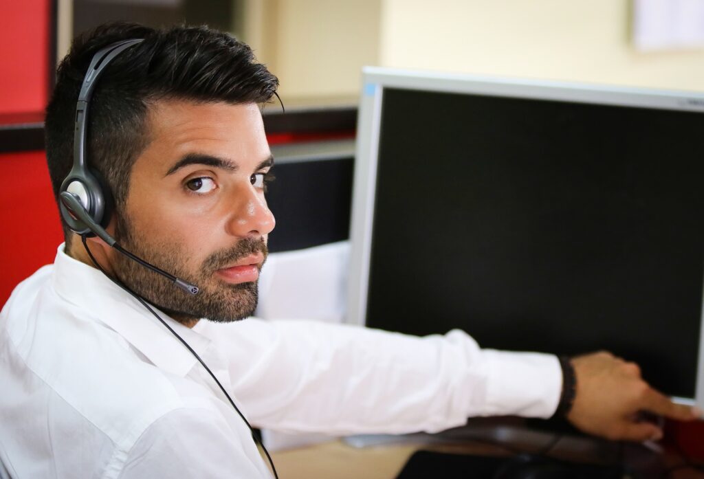 Call center representative turning on his computer screen
